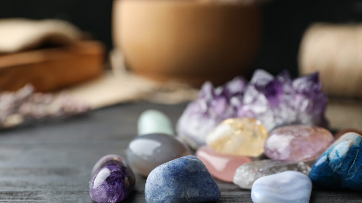 Colorful healing gemstones on a wooden table
